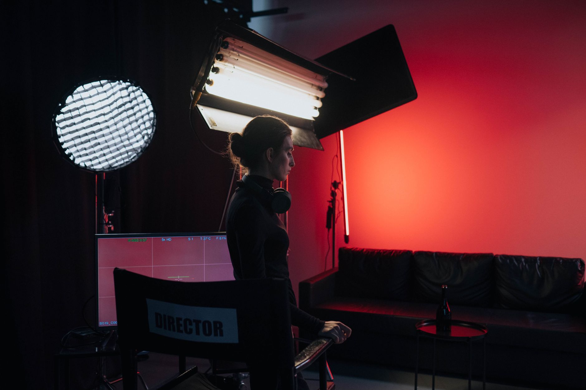 woman in all black outfit standing in front of director s chair